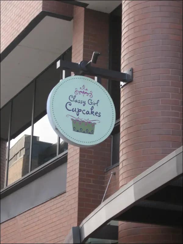 Custom scroll bracket sign mounted for outdoor or indoor display