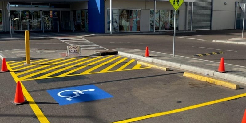 Parking lot floor graphics with accessible parking symbol