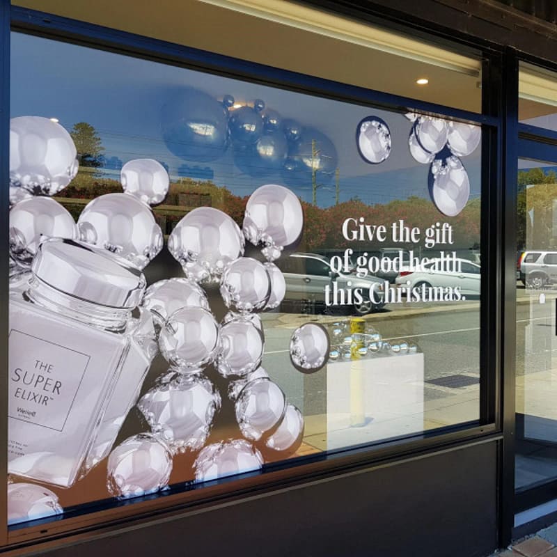Eye-catching holiday window signage for retail store promotion