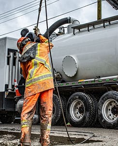 Heavy-duty vacuum truck in action on site